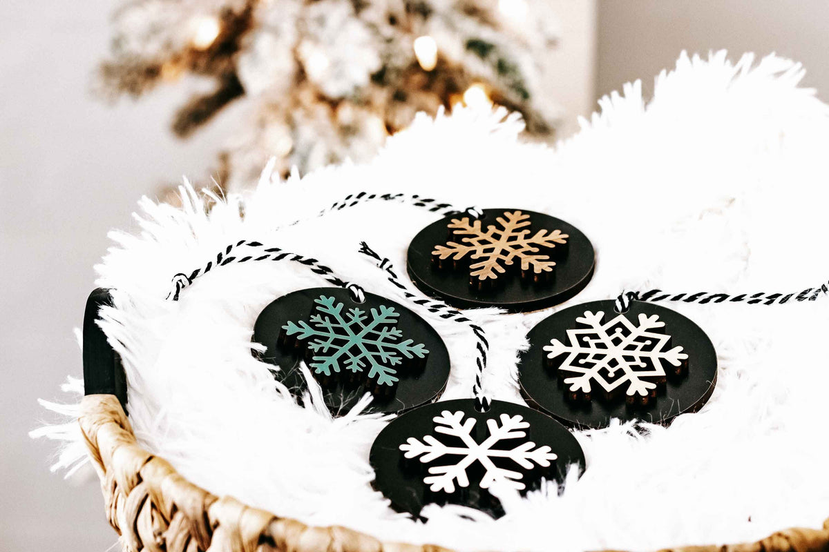 Set of 8 black wooden snowflake ornaments with white snowflake and gold accent