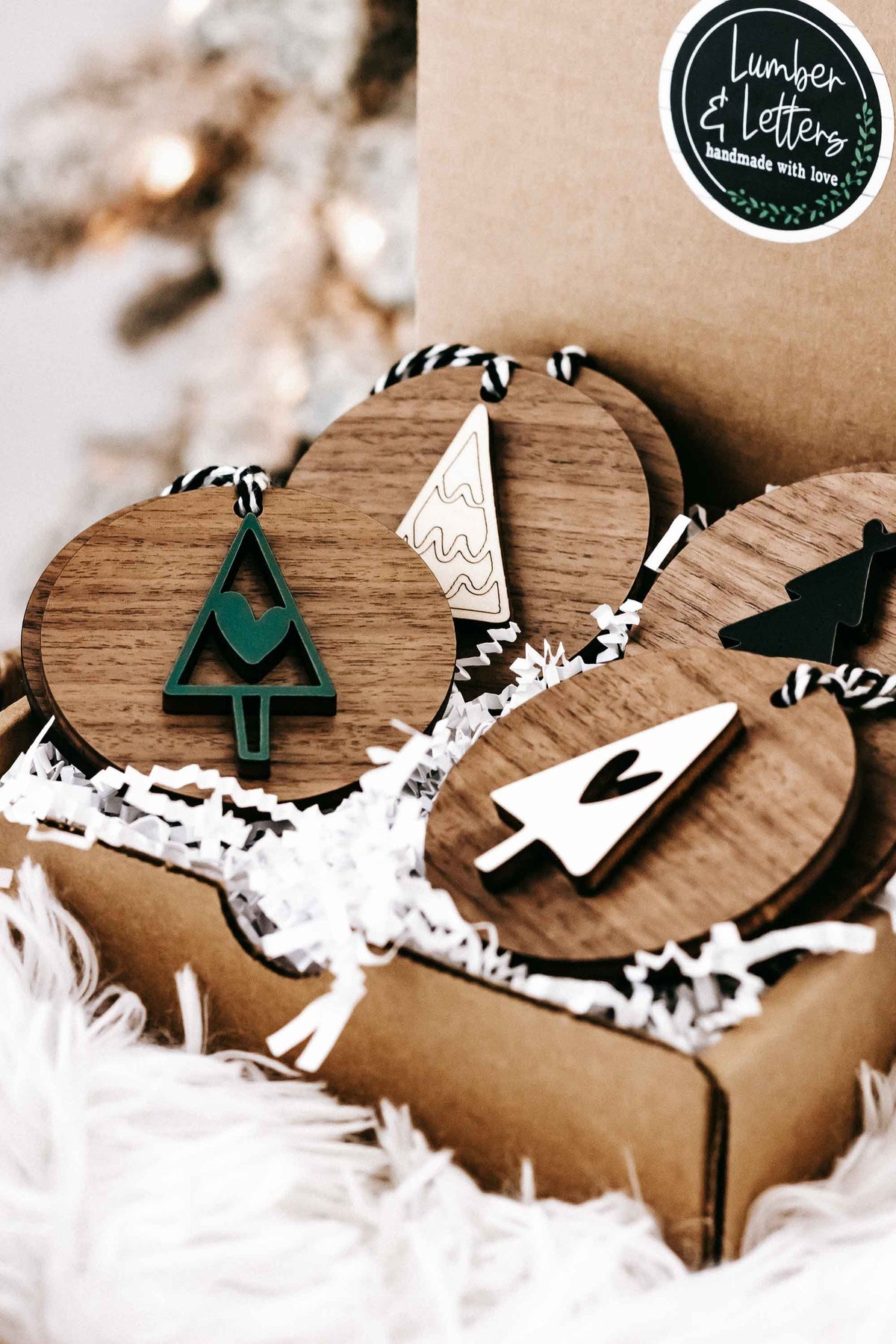 Wooden ornament set in kraft box with tree, heart, and star shapes on striped hangers