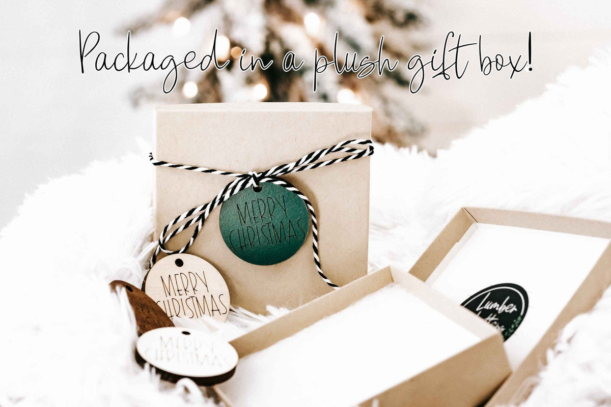 Gift box with plush wrap containing “Merry & Married” round ornaments and twine
