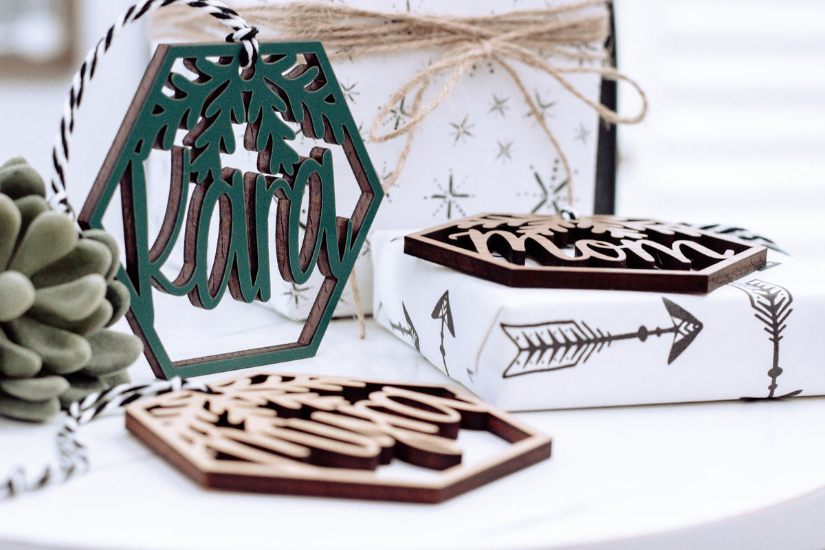 Wood hexagon name ornament with laser-cut leaves and gift box, green and walnut