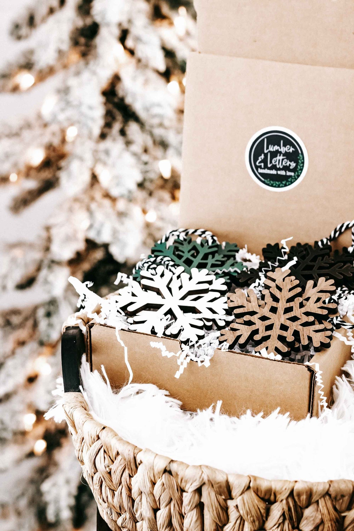 Wooden snowflake ornaments in woven basket, dark, white, green, and natural wood pieces