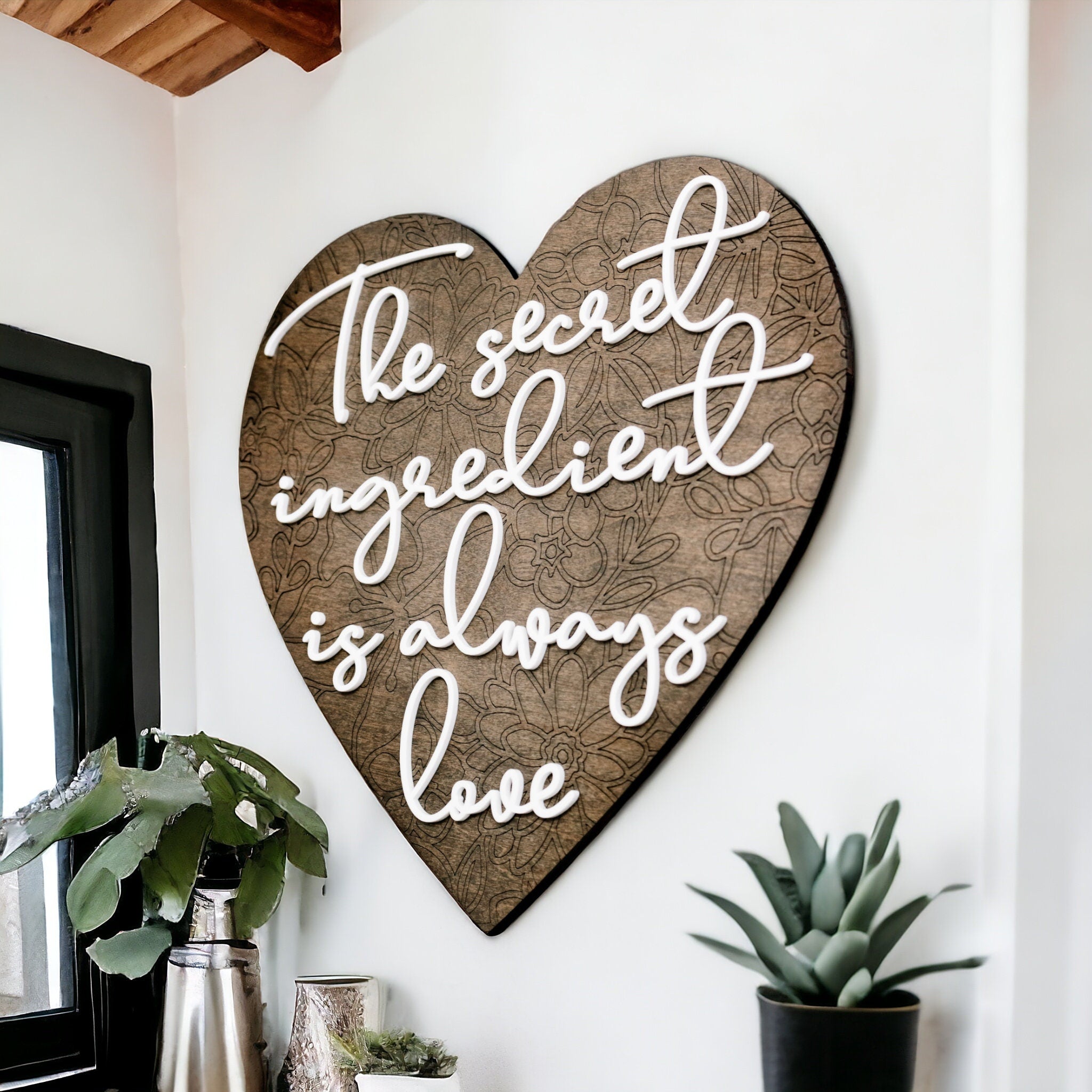 Brown heart kitchen wall art with white cursive text: secret ingredient is always love