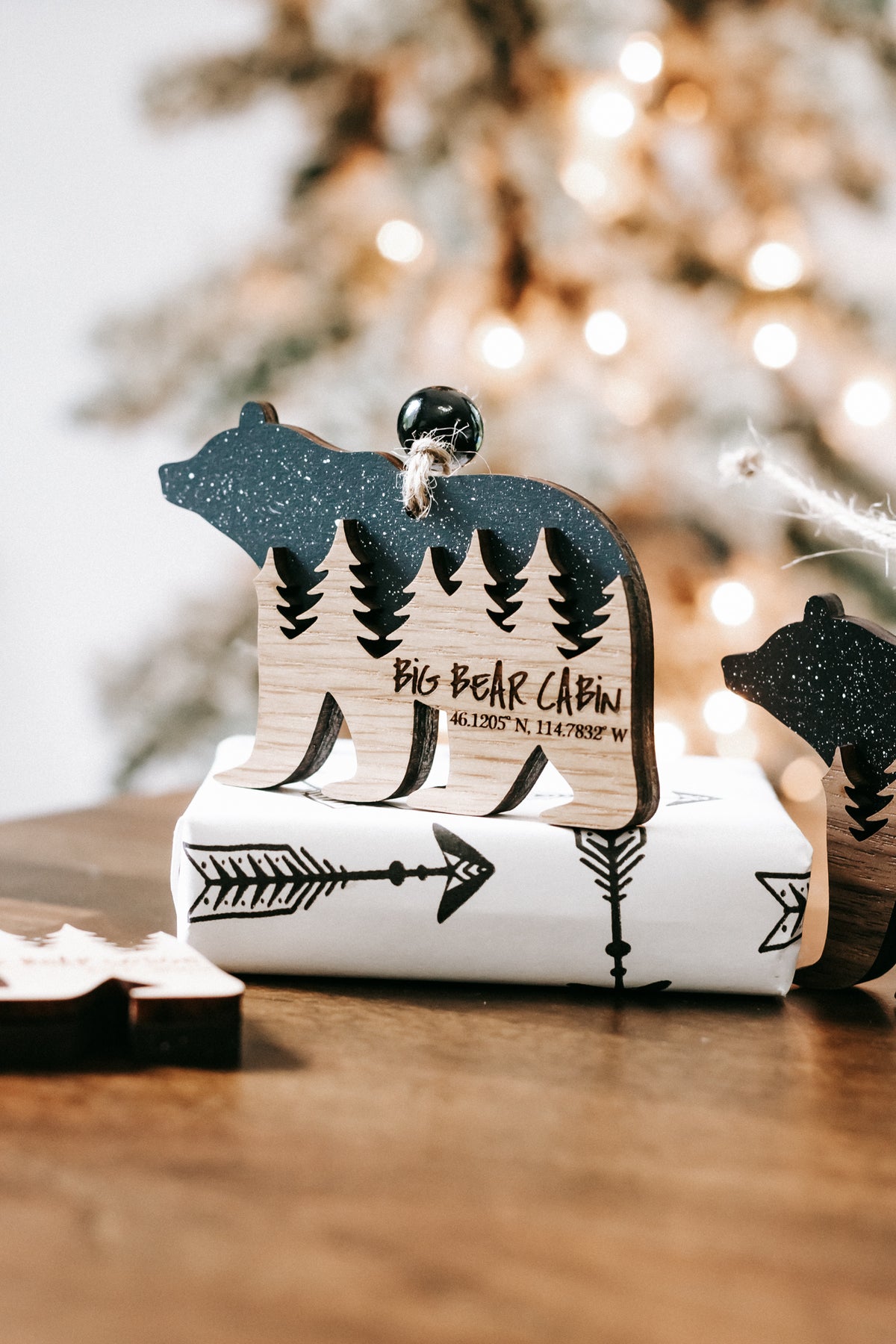 Dark glitter bear-shaped cabin ornament with engraved pine trees and cabin text