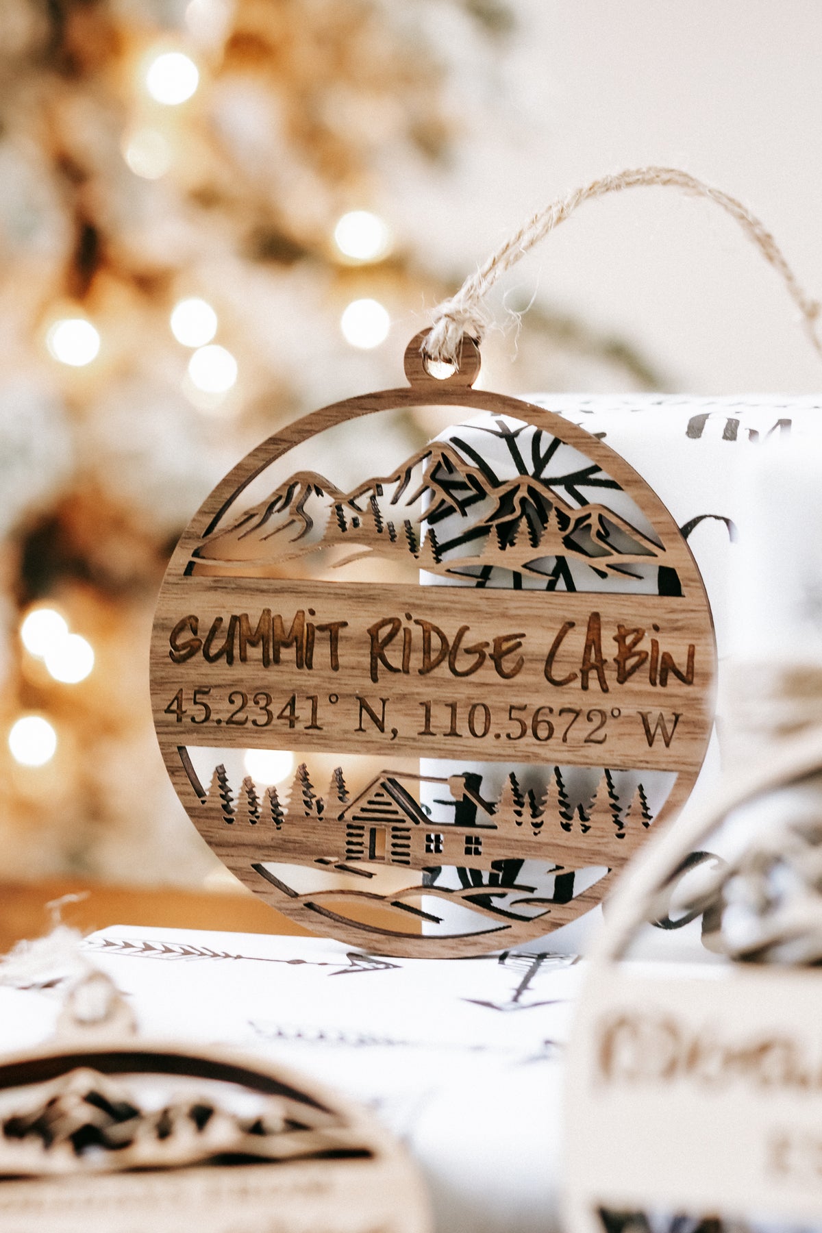 Engraved round wood “SUMMIT RIDGE CABIN” ornament with coordinates, rope hanger