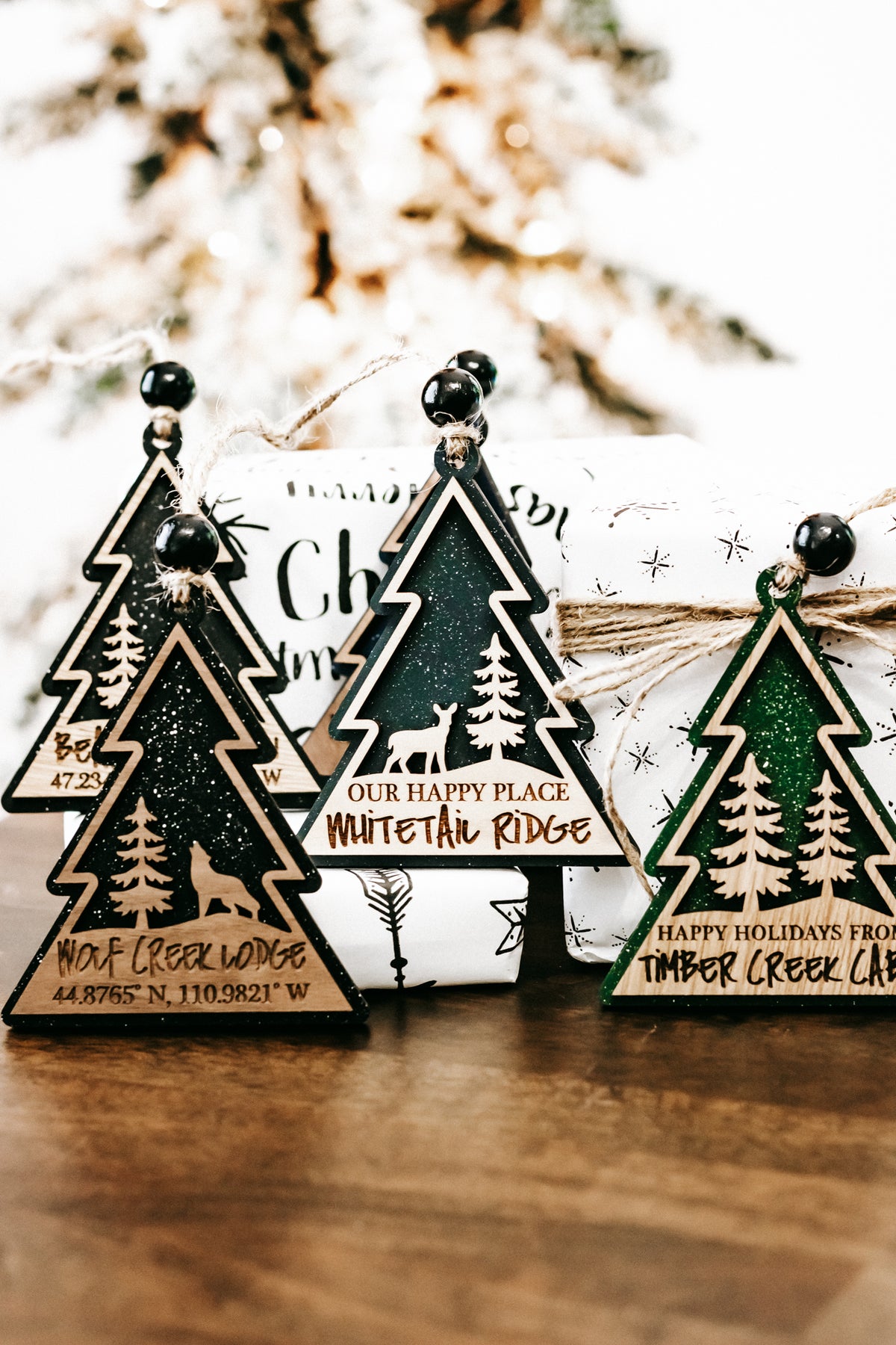 Hanging tree-shaped ornaments with cabin sign wording and small star accents