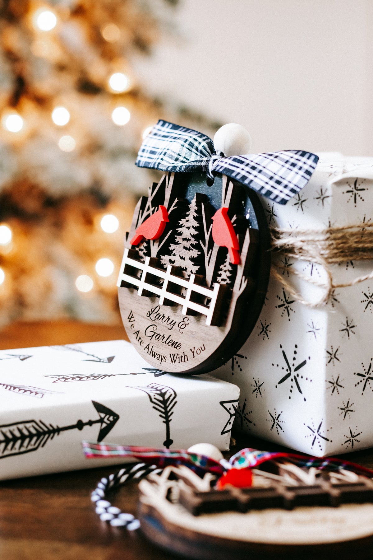 Personalized memorial ornament with red cardinals, plaid bow, forest fence scene
