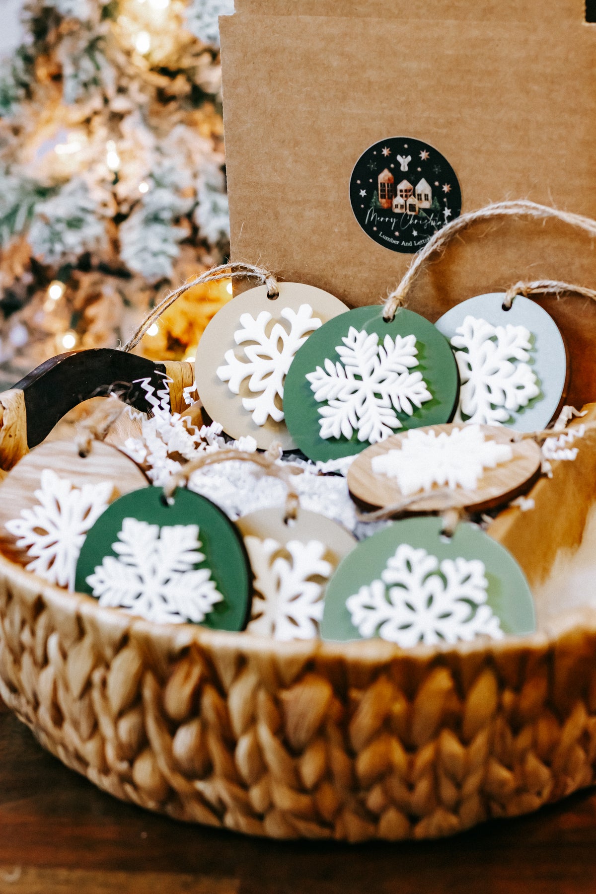 Set of hanging layered snowflake ornaments, white snowflakes on green discs