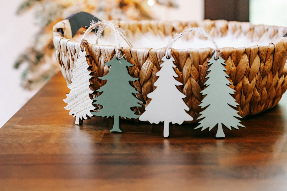 Wooden Christmas tree ornaments on display, mixed white, green, and natural wood colors