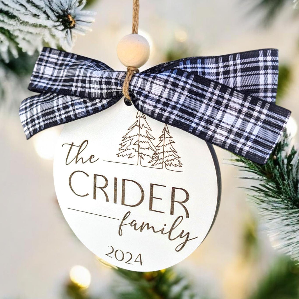 Family name Christmas ornament with navy and white plaid bow, “The CRIDER family 2024”