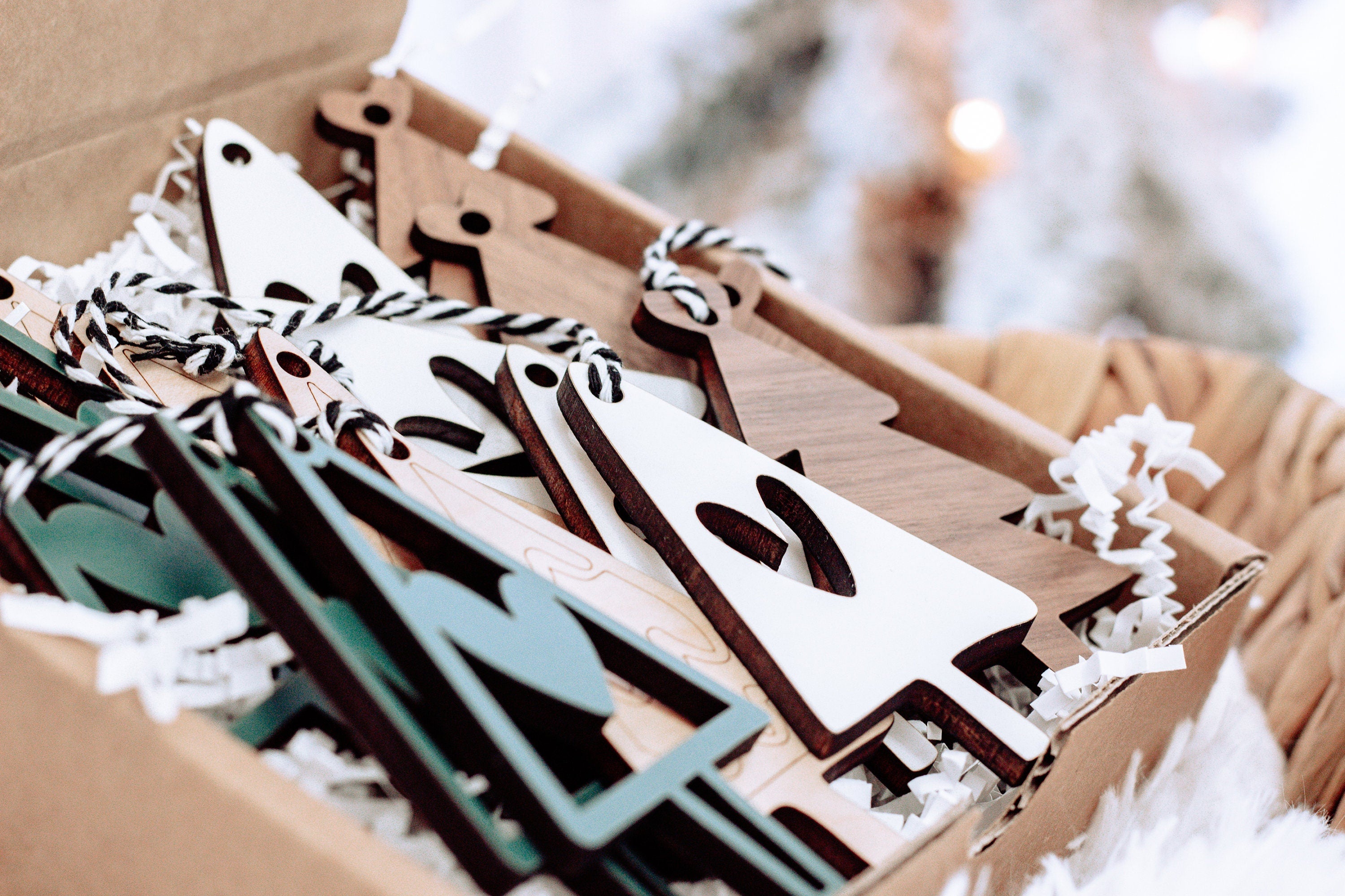 Boxed set of wooden Christmas ornaments: green and white tree shapes with string hangers