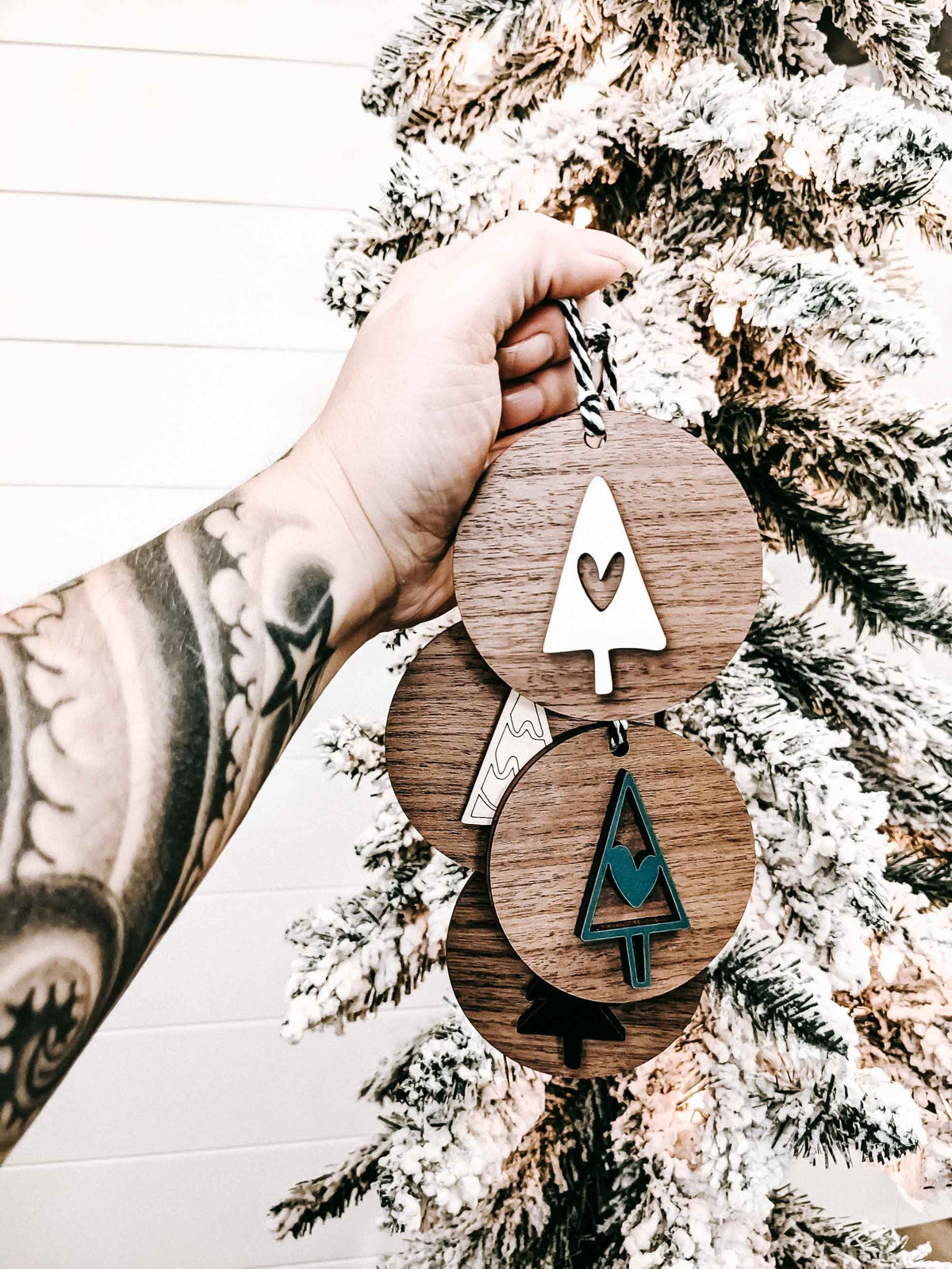 Hanging set of wooden ornaments with tree, heart, and star shapes on striped string hangers