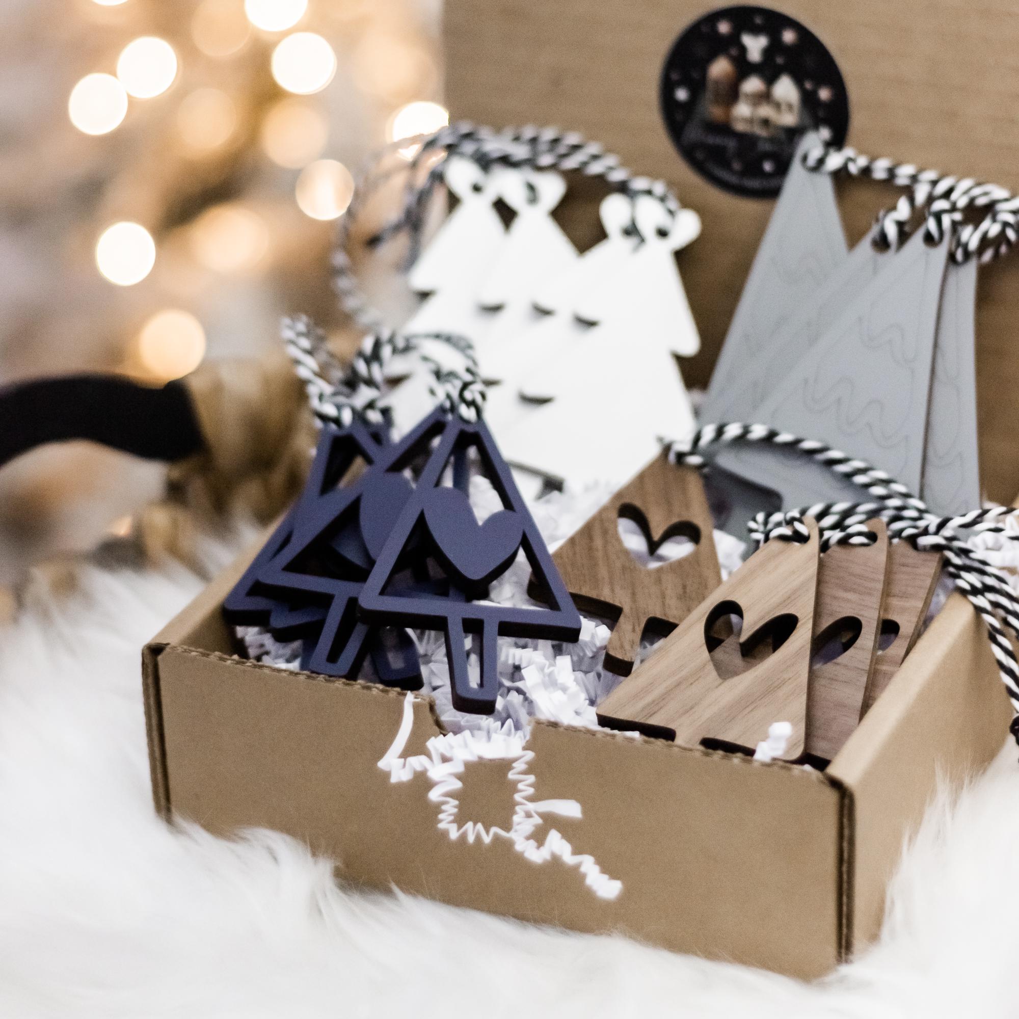 Wooden Christmas tree ornament set featuring navy tree cutouts and heart-shaped pieces