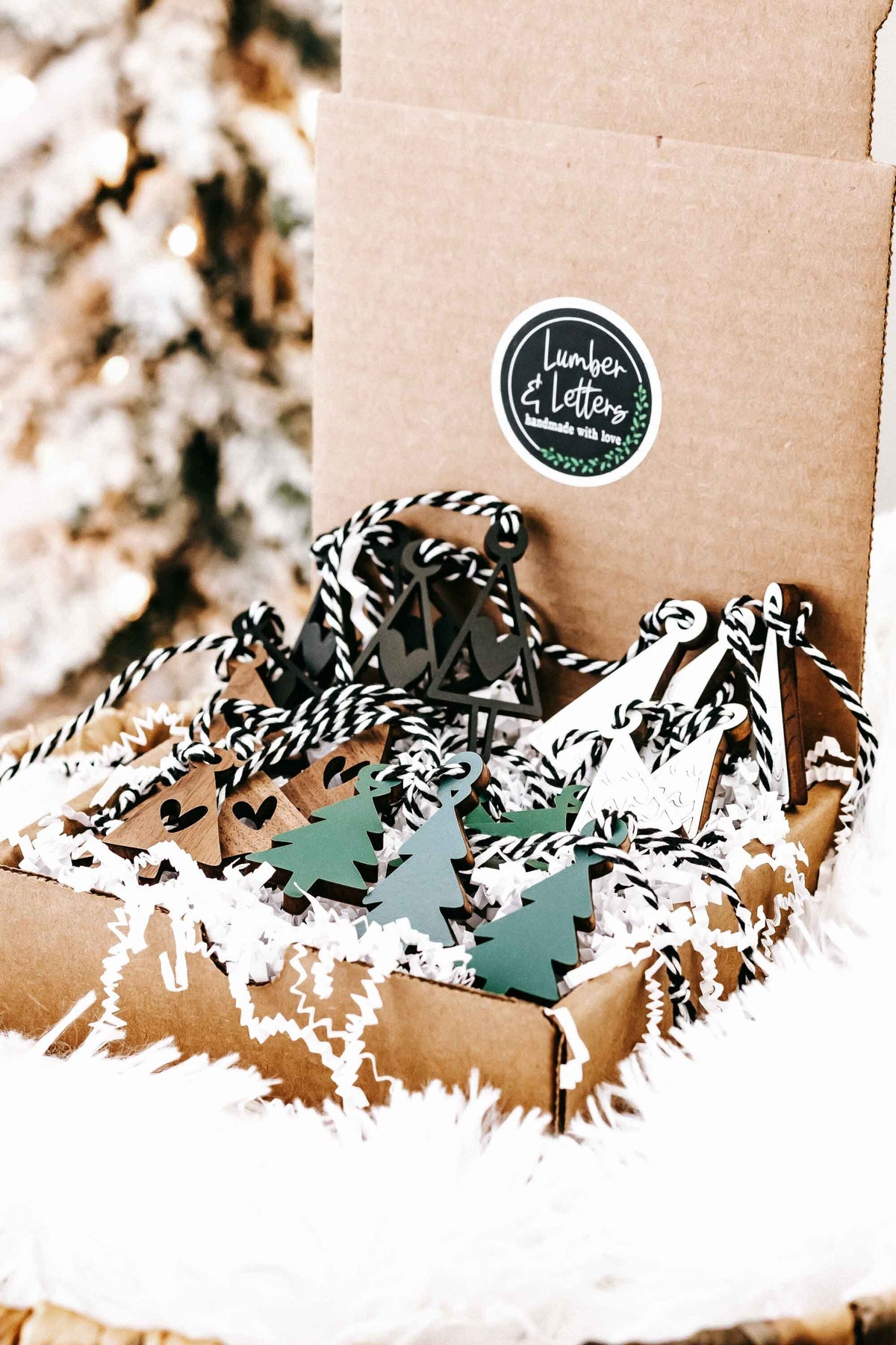 Set of mini wooden Christmas tree ornaments in brown, green, black, and white