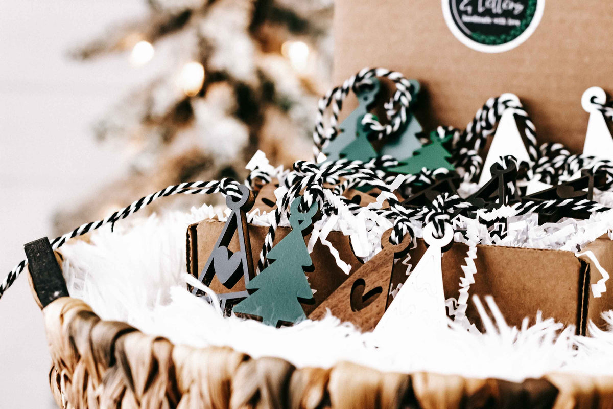 Set of mini wooden Christmas tree ornaments with hanging loops in green, black, and brown