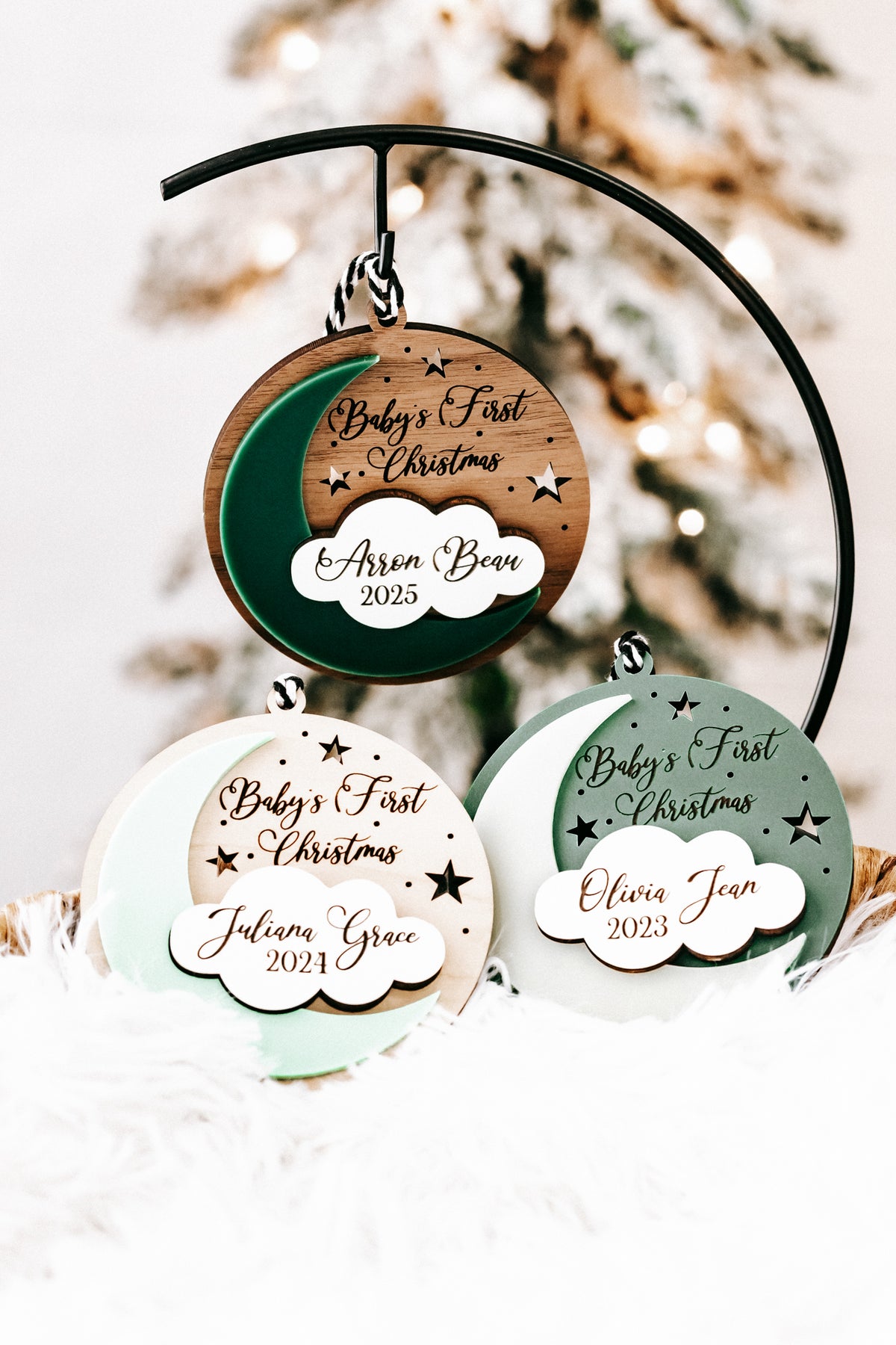 Hanging round ornaments with cloud tags: Aaron Bear 2025, Julia Grace 2024, Olivia Jean 2023.
