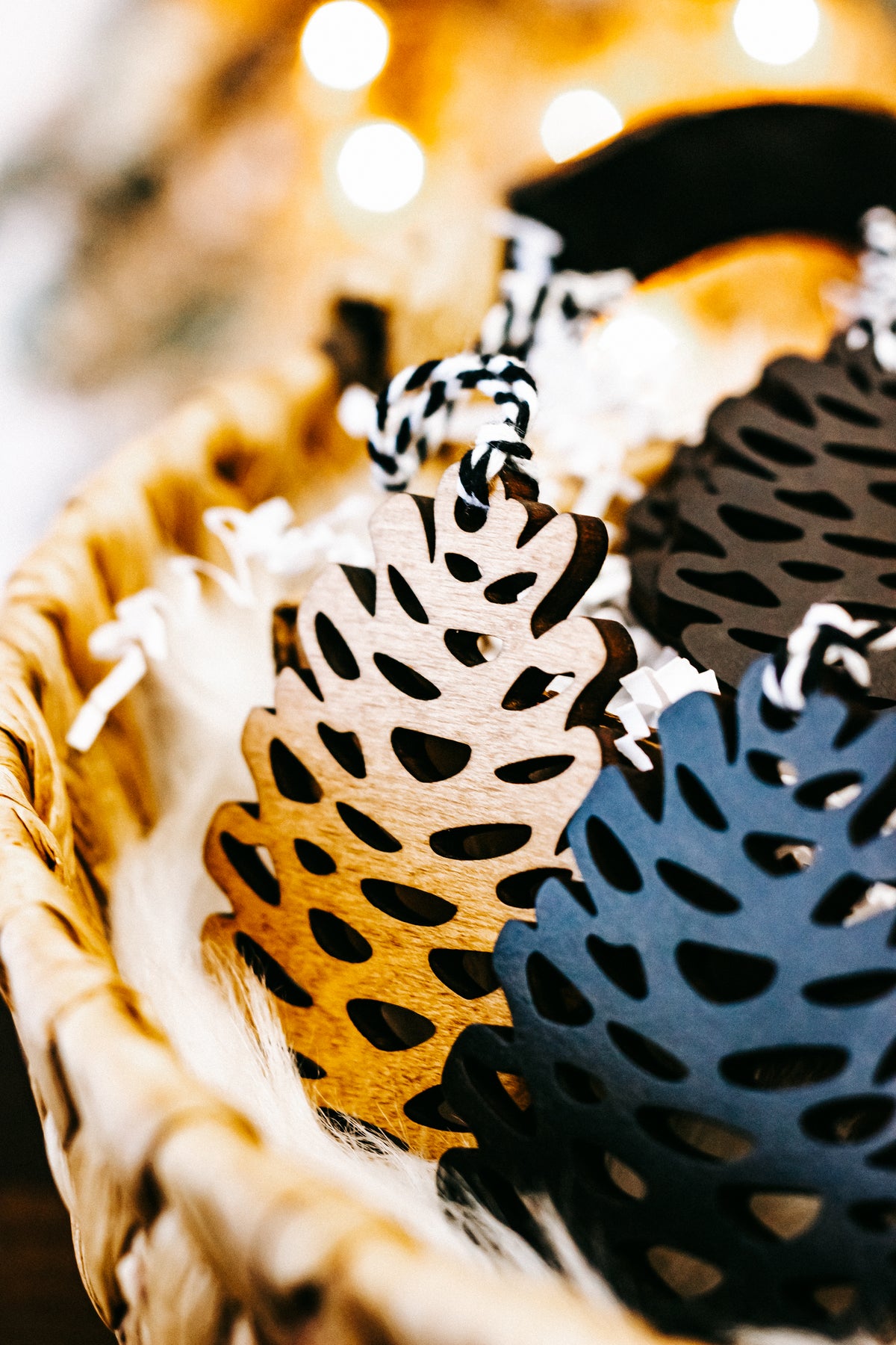 Hand-stained wooden pinecone ornament details in amber and dark tones with twine