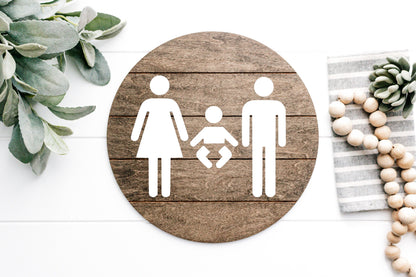 3D restroom changing room sign, round dark wood with white male, female and baby icons
