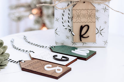Personalized wood stocking tags with Nordic print and letter R, tied with twine