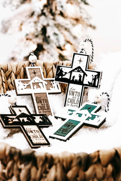 Multiple nativity cross ornaments with star, manger silhouettes, and verse text “Isaiah 9:6”