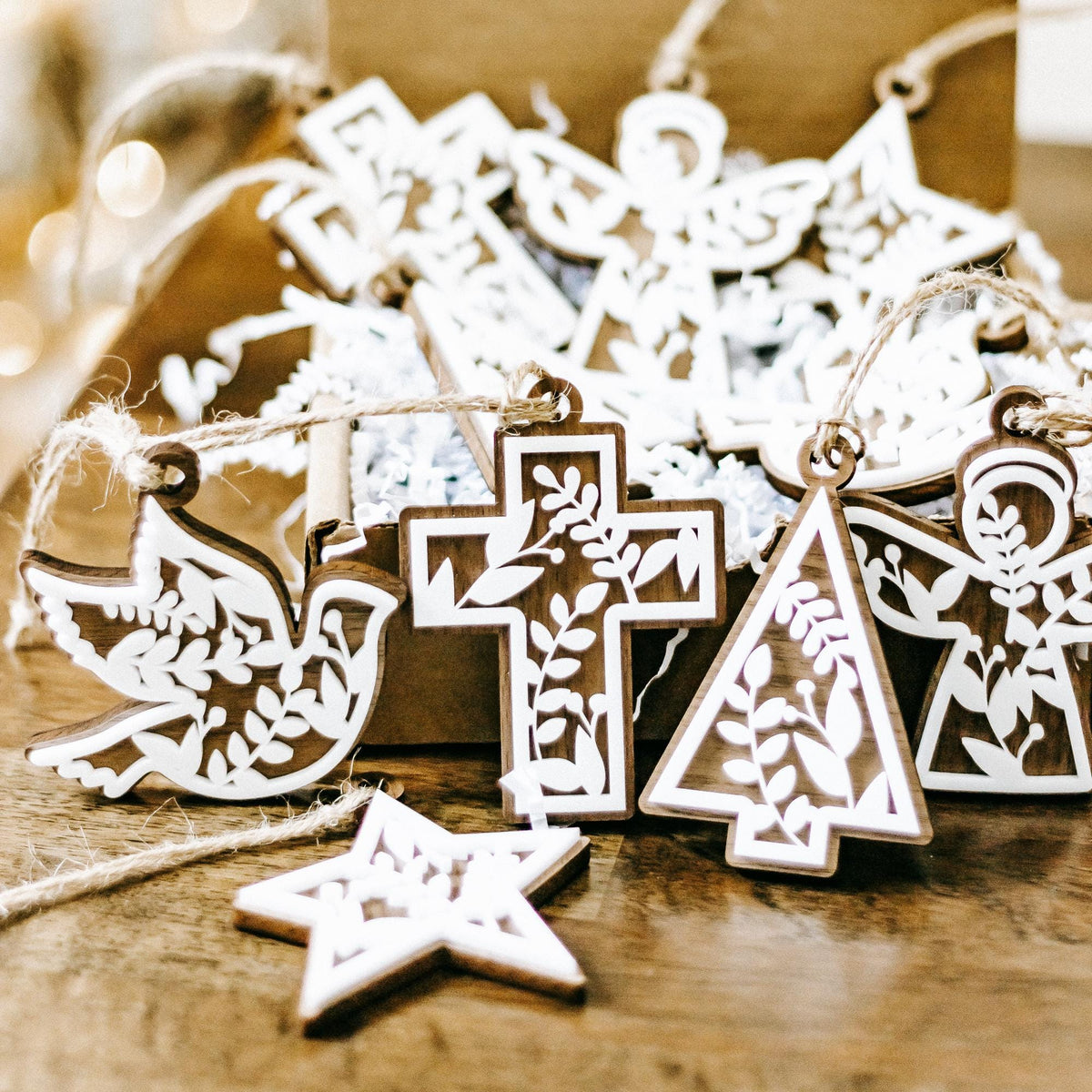 Set of 10 floral cutout ornaments with star, cross, and tree angel designs on twine