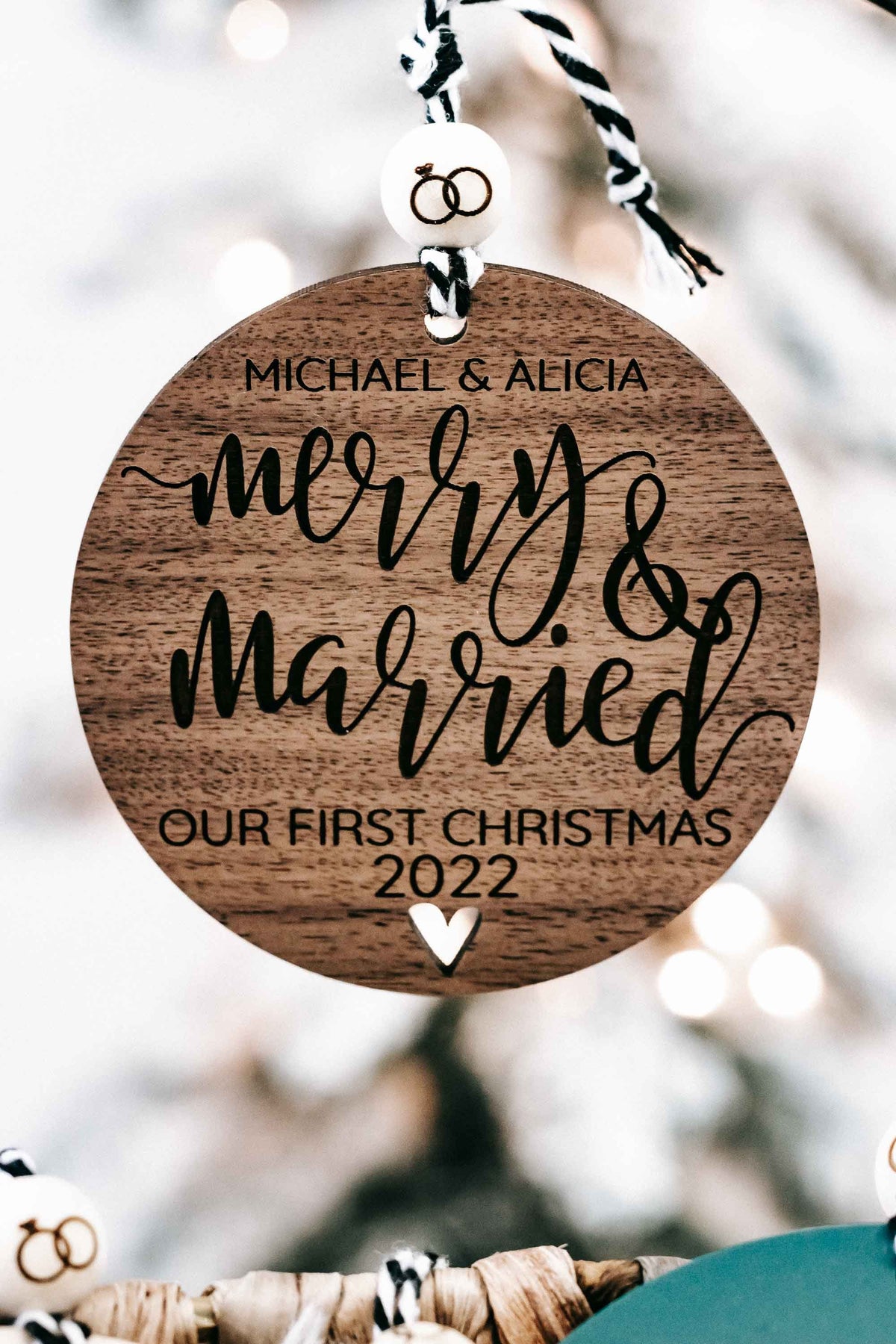 Brown round Christmas ornament with “Merry &amp; Married” and “Our First Christmas 2022”