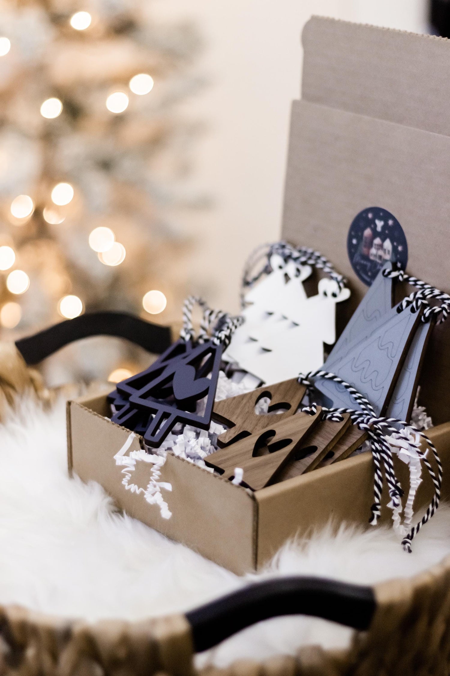 Set of 16 wooden Christmas tree ornaments with navy, white, and gray hanging strings