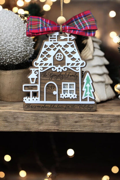 Wood gingerbread house ornament with red plaid bow, “842,” mailbox, and teal tree cutout