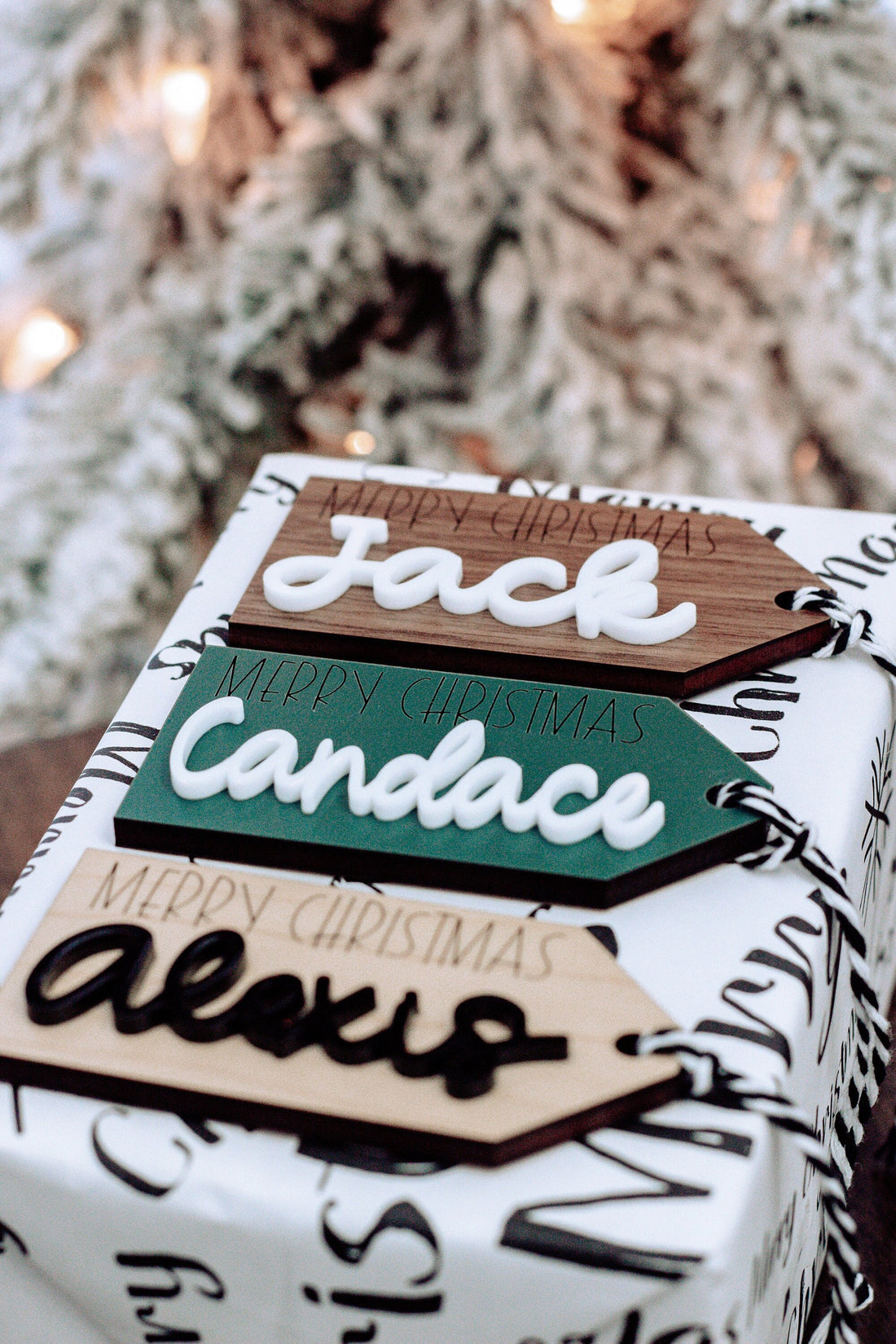 Wood gift tag with Canada name, Merry Christmas text, and hanging black-and-white twine