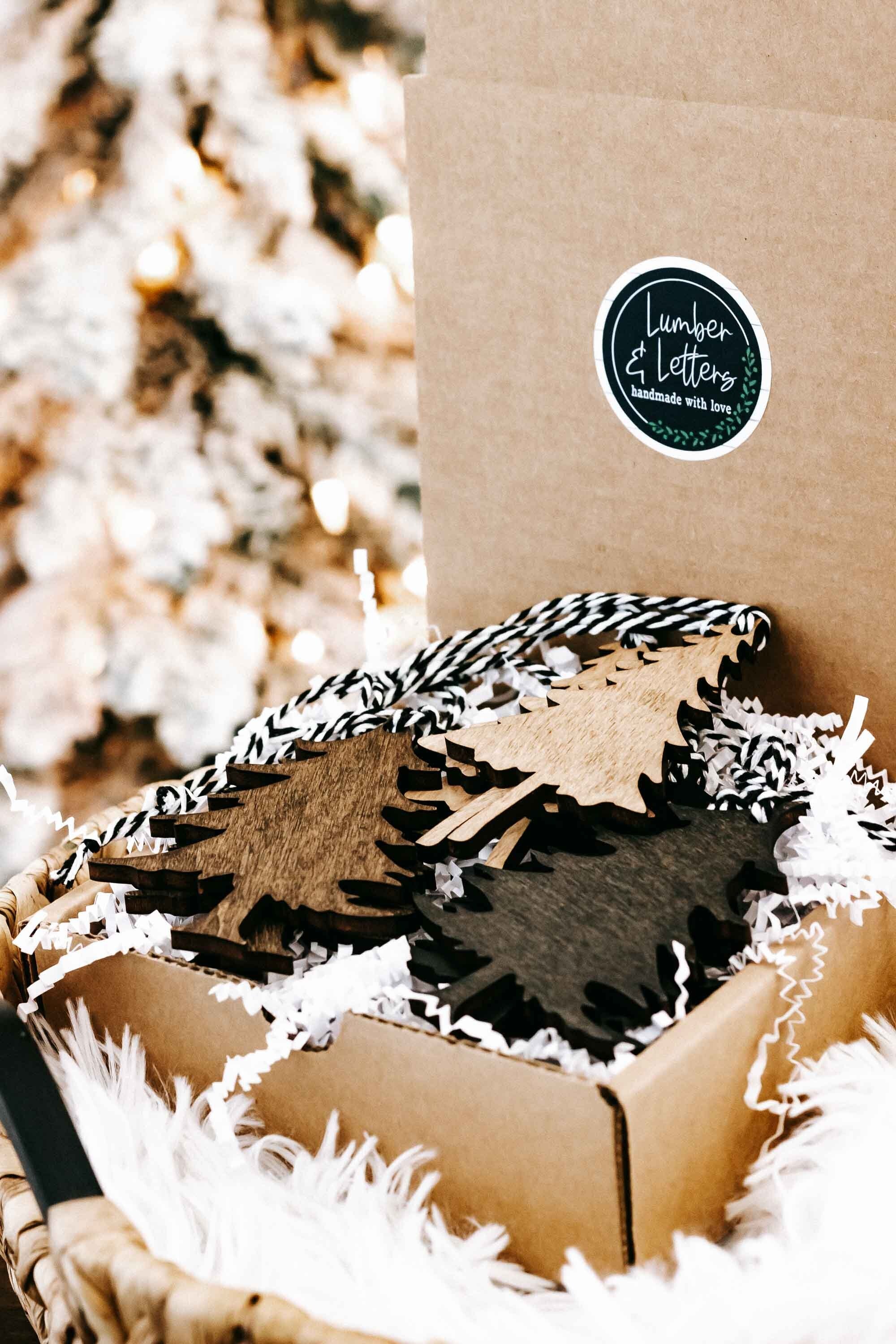 Rustic Christmas tree ornament set in kraft box with black-and-white striped strings.