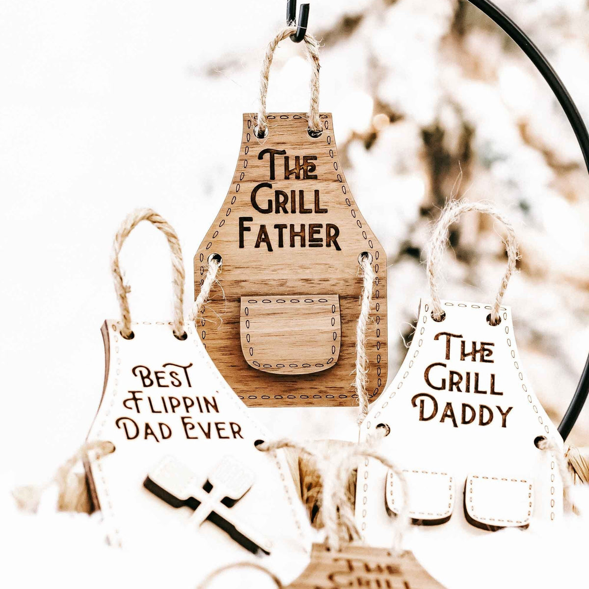 Wood grill-themed ornament set with “The Grill Father,” “Best Flippin’ Dad Ever,” and “The Grill Daddy.”