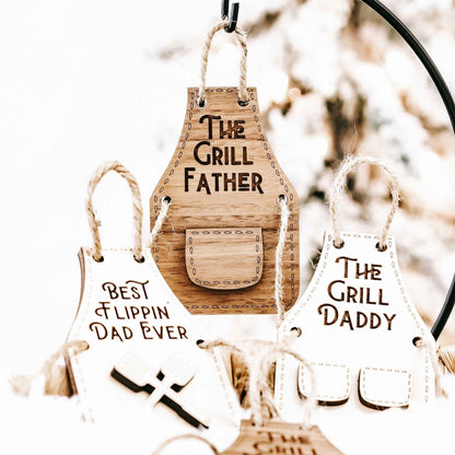 Wood grill-themed ornament set with “The Grill Father,” “Best Flippin’ Dad Ever,” and “The Grill Daddy.”