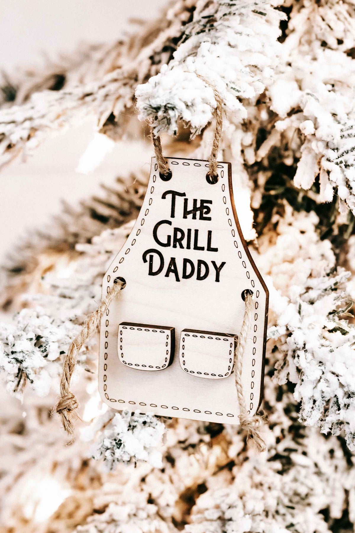 Wood “The Grill Daddy” ornament with two front pocket cutouts on a hanging tag.