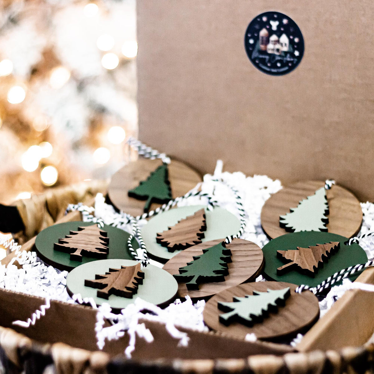 Set of wooden Christmas tree ornaments with mixed painted faces and striped string hangers