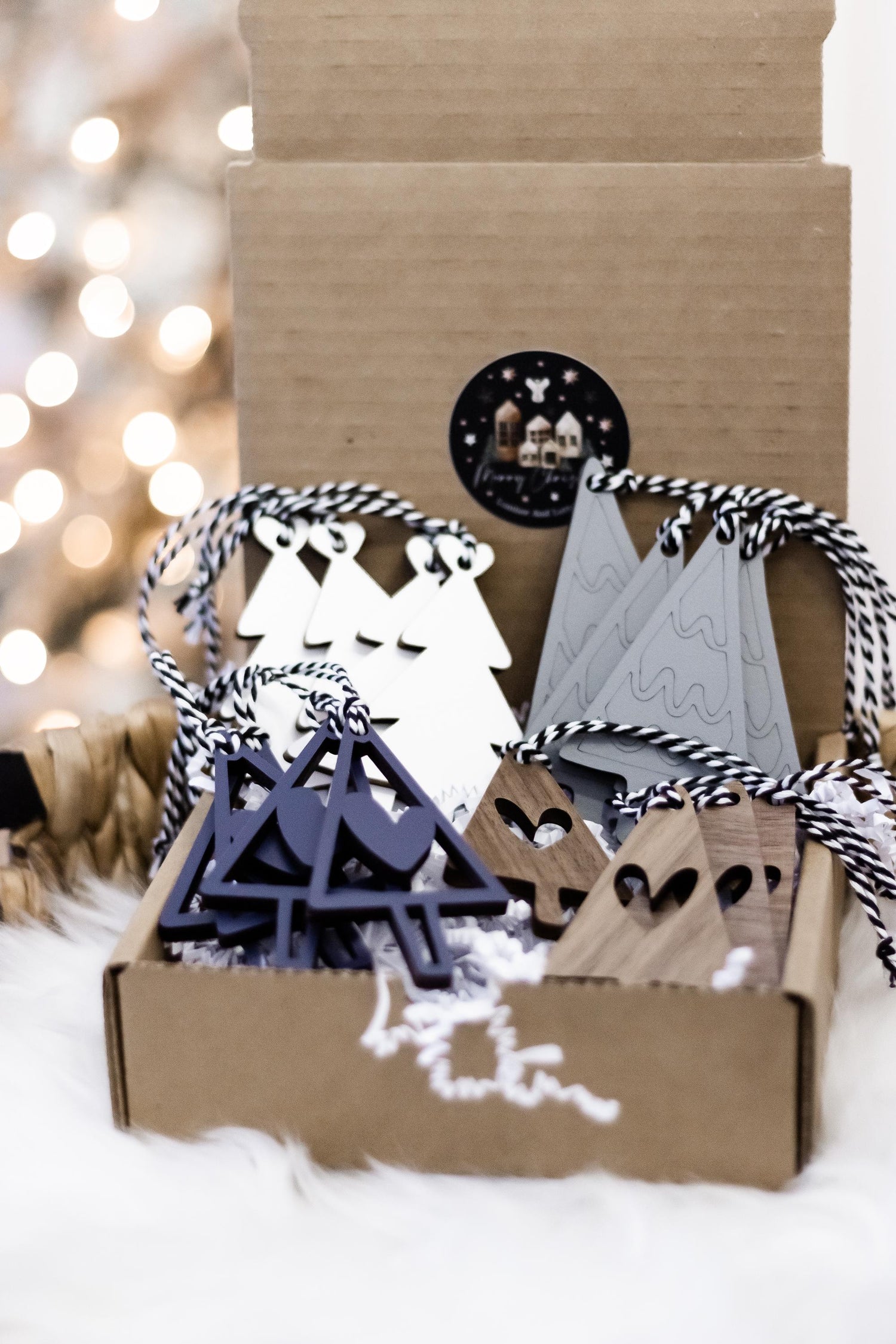 Set of wooden Christmas tree ornaments with navy, white, and gray hanging pieces