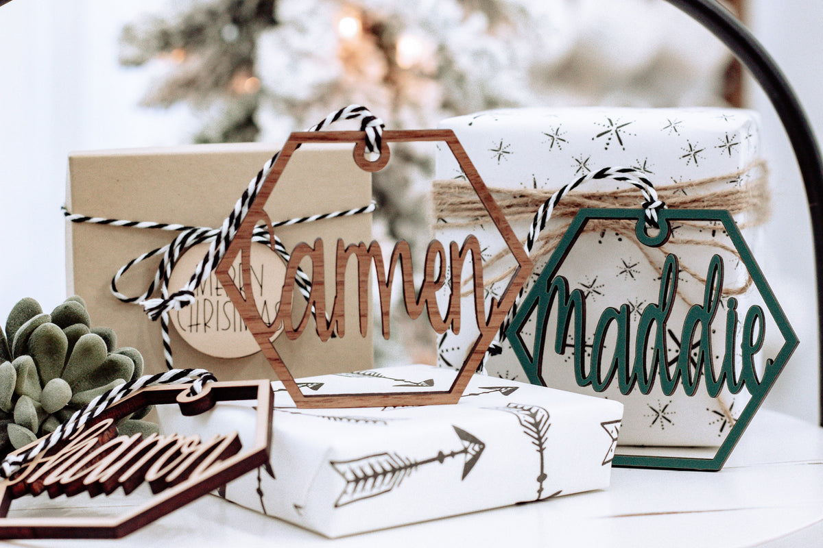 Wooden hex name ornament with cursive “Tammon” engraving, dark green outline, twine loop