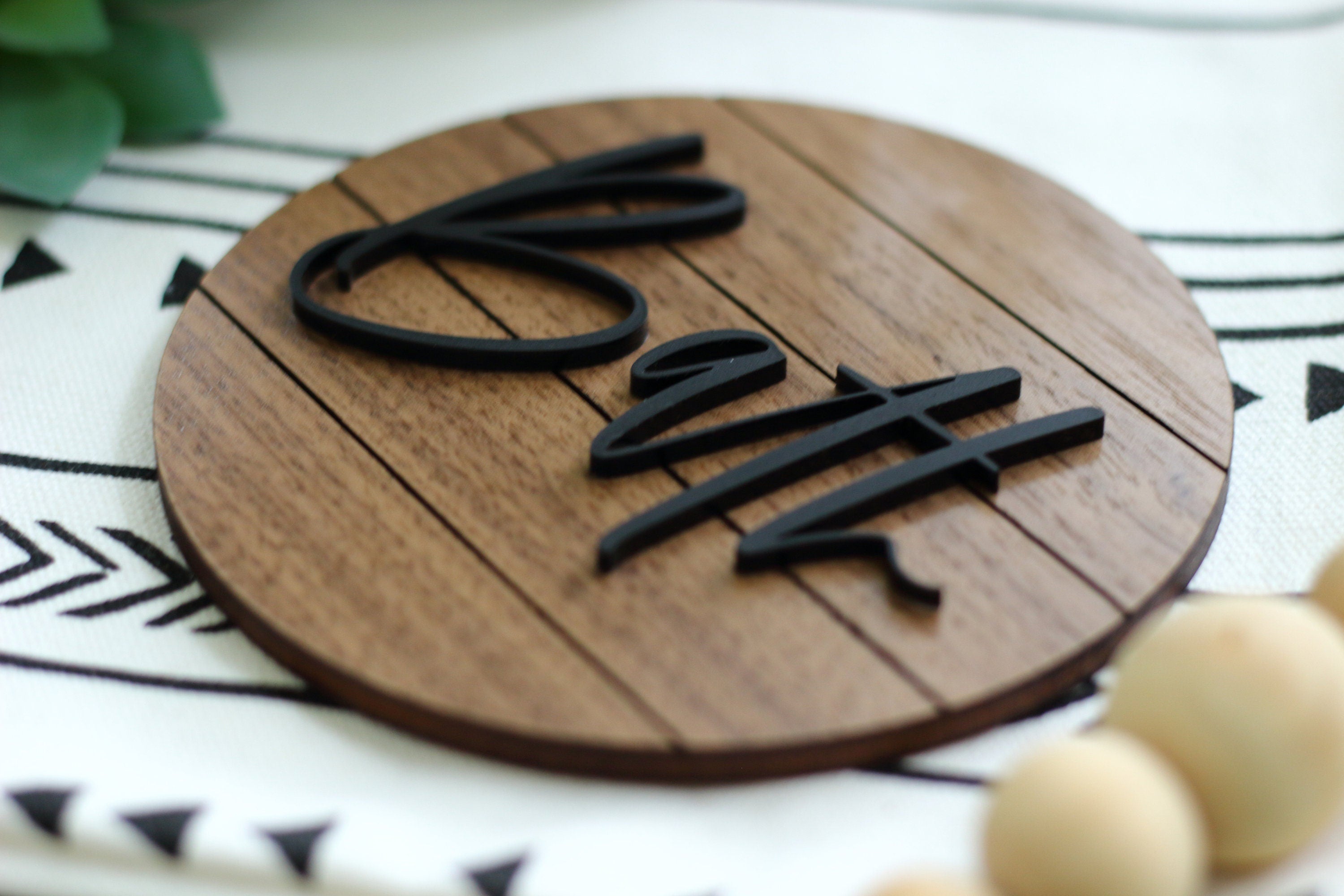 Round wood bath wall sign with 3D black “Bath” lettering