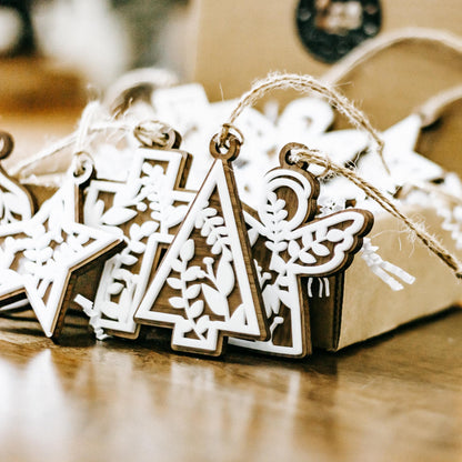 Assorted floral cutout Christmas ornaments with cross and angel shapes, hanging twine loops