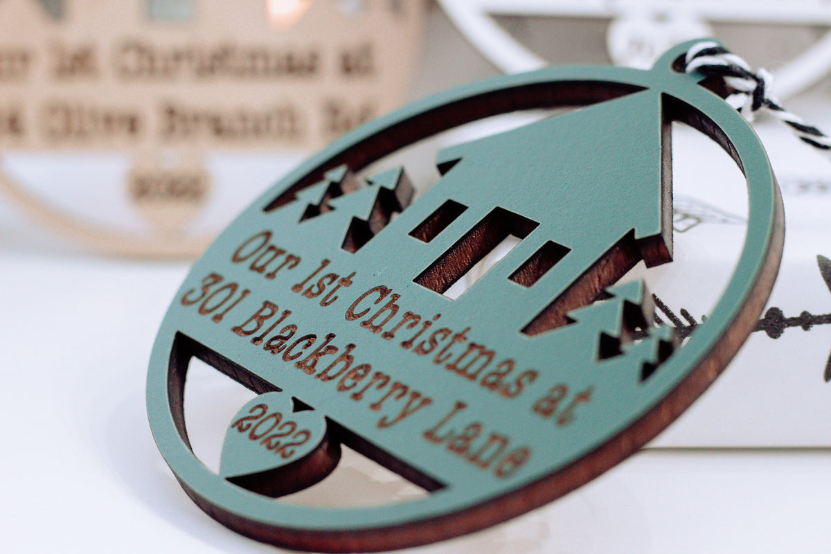 Oval wooden Christmas ornament with laser-cut pattern, hanging loop, and year text