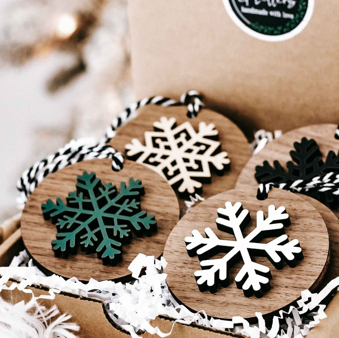 Set of wooden snowflake Christmas tree ornaments with striped hanging loops