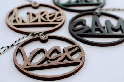Wooden laser-cut custom name ornaments with hanging loops, dark and light wood set