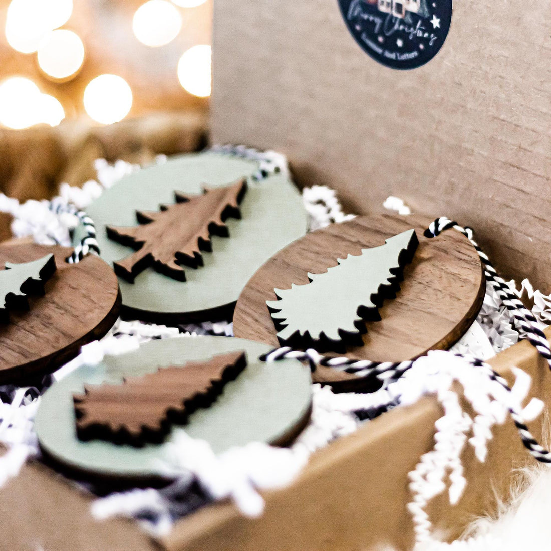 Set of wooden Christmas tree ornaments with striped hanging cords and scalloped edges