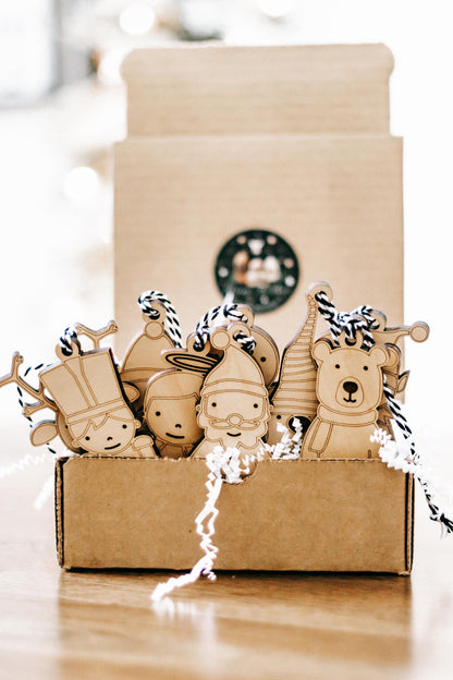 Set of 10 wooden Christmas character ornaments in a gift box, rope-hung nutcracker and bear