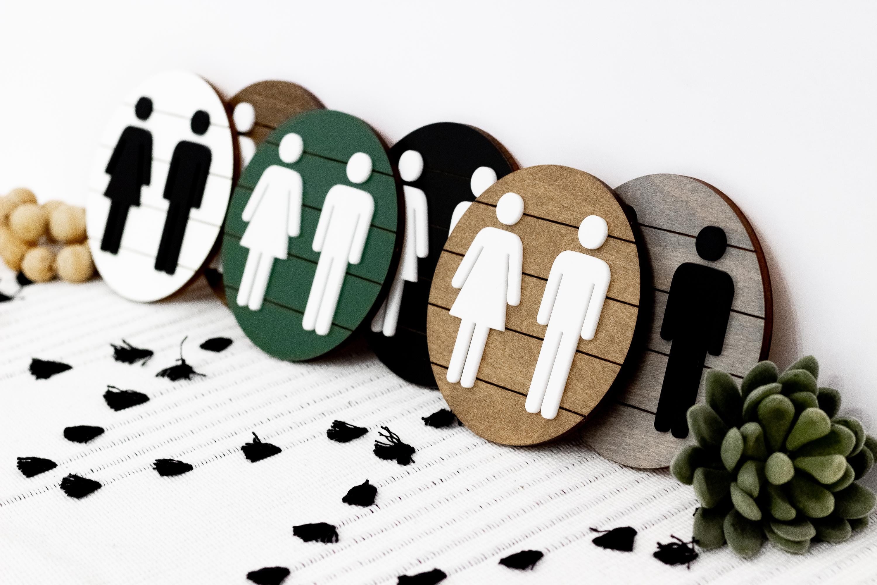 3D restroom changing room signs cluster, round wood and colored backgrounds with icons