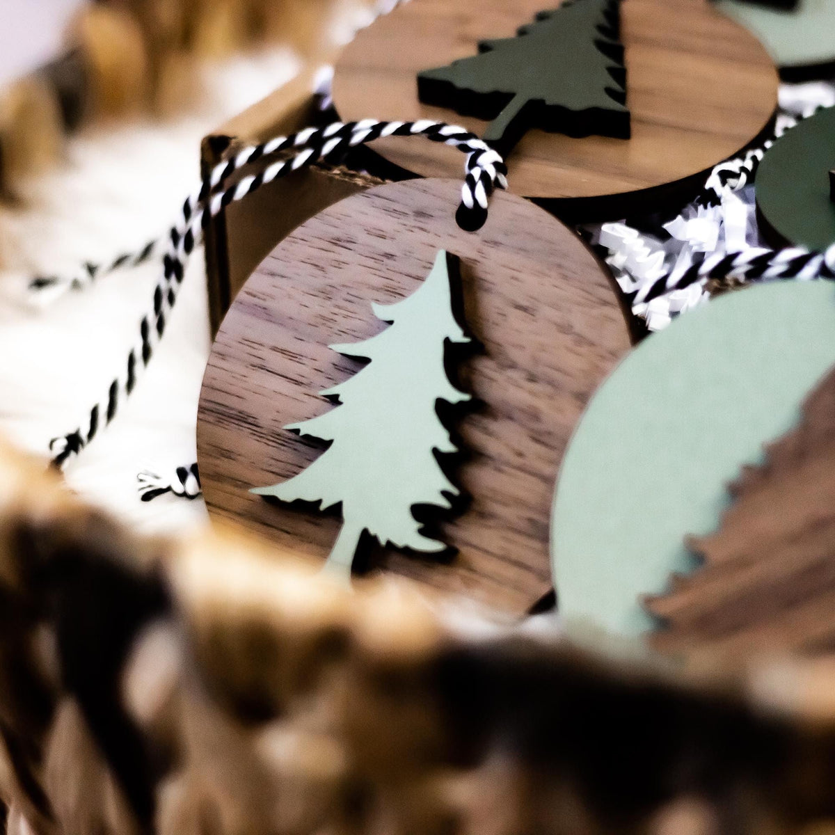 Wooden Christmas tree ornament with cutout tree design and striped string hanger