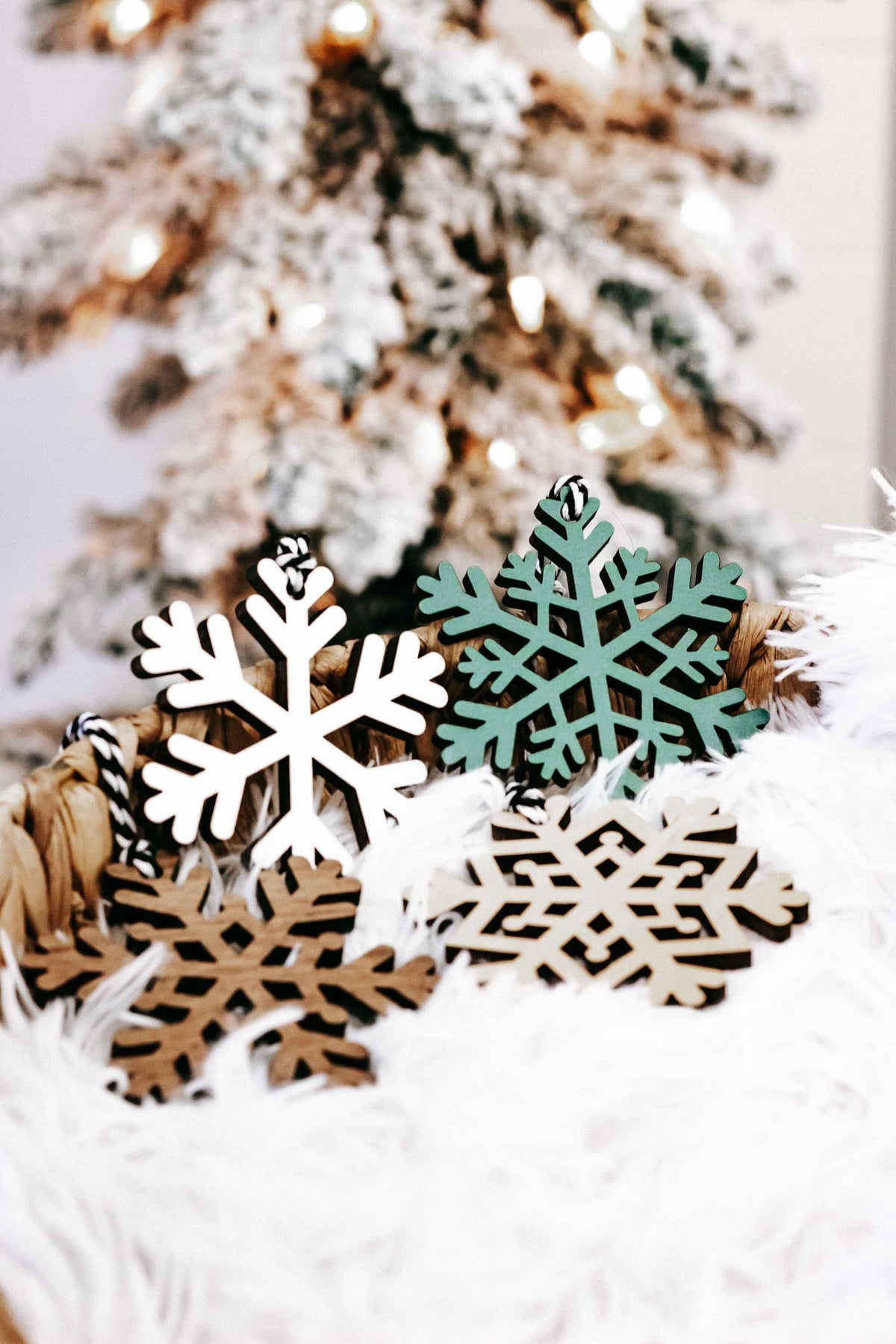 Handheld set of snowflake wood Christmas ornaments, white and dark green with black hooks