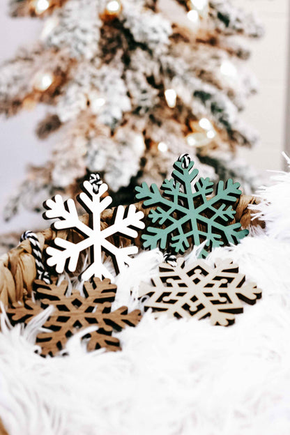 Handheld set of snowflake wood Christmas ornaments, white and dark green with black hooks
