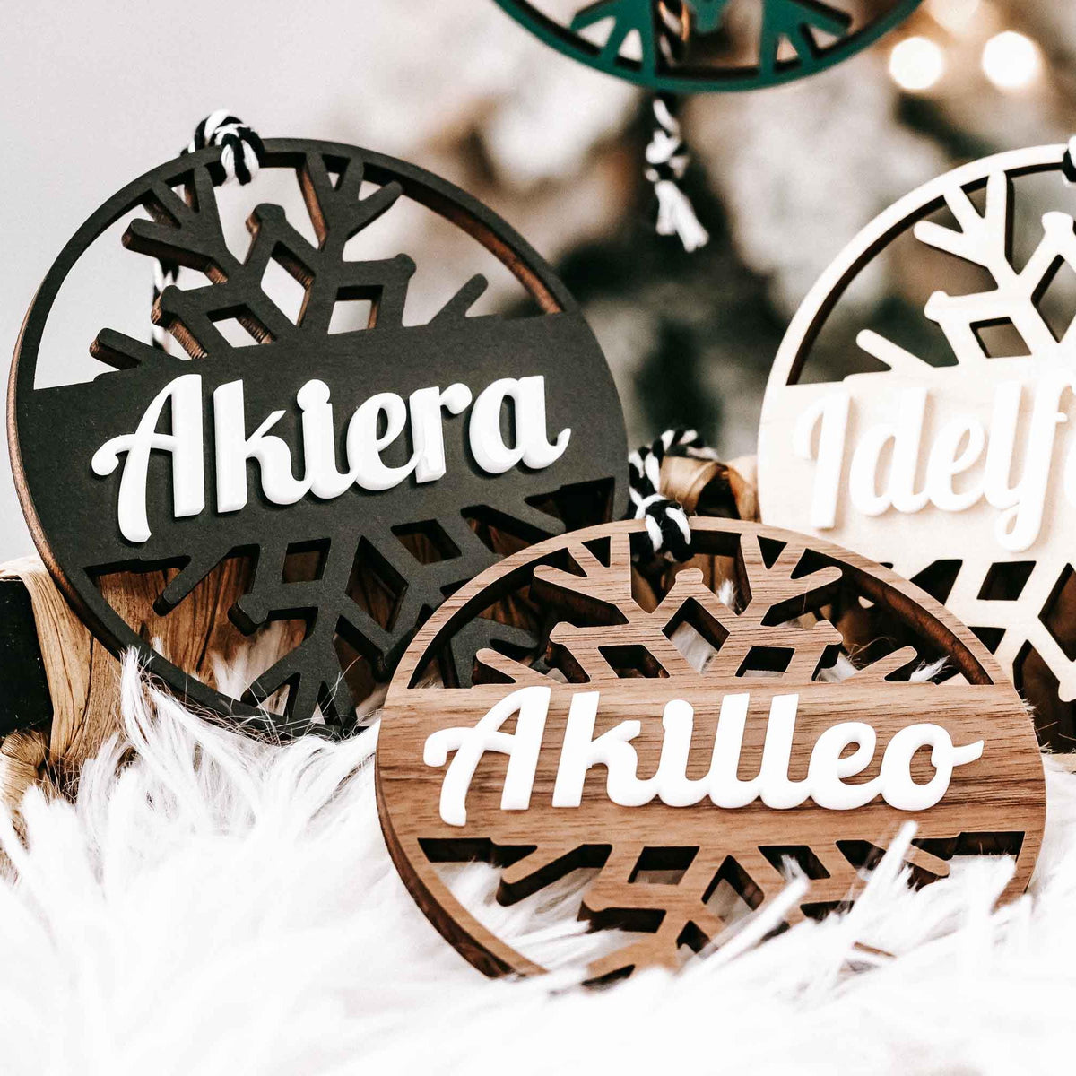Personalized snowflake ornaments, dark and light round tags with white script names