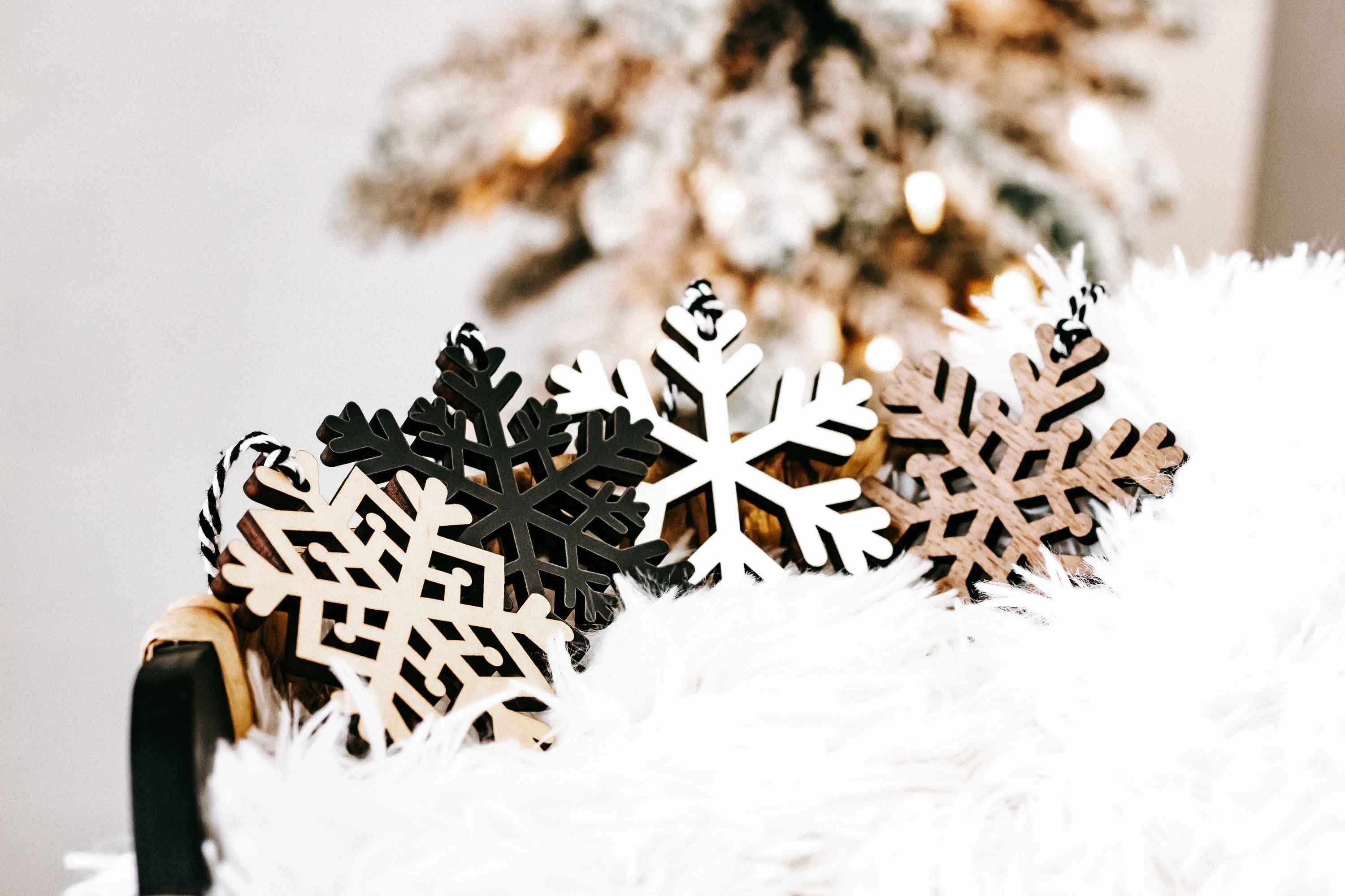 Snowflake ornament set on white filler: white, dark, and tan cutout snowflakes