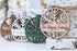 Round engraved family name Christmas ornament with tree cutout, light wood and dark outline