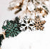 Set of wooden snowflake ornaments in dark, white, green, and natural wood accents